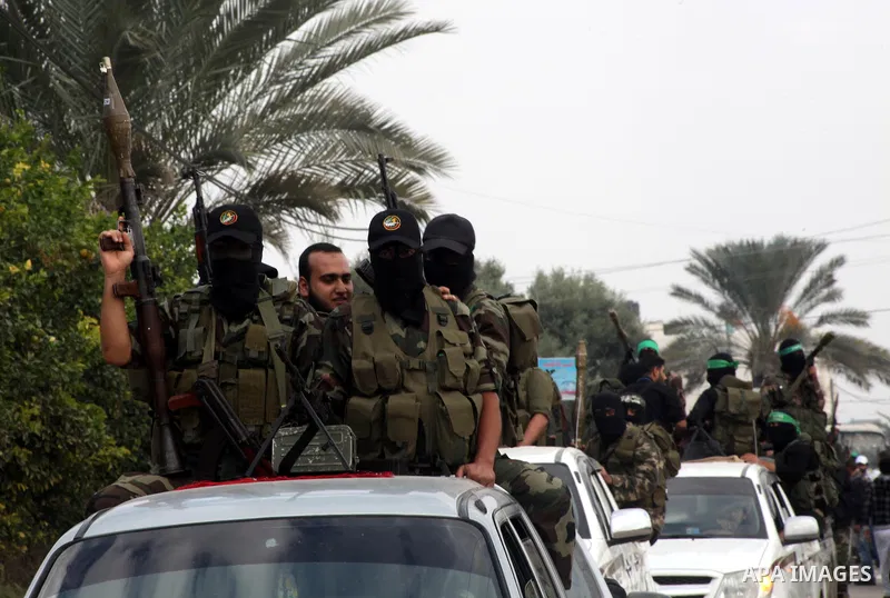 Hamas militants ride in a pick-up truck as they take part in the funeral of their comrades, whom medics said were killed in Israeli air strikes on Wednesday, in the central Gaza Strip November 22, 2012. A ceasefire betwe...