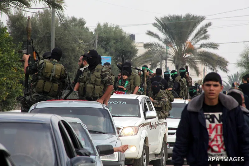 Hamas militants ride in a pick-up truck as they take part in the funeral of their comrades, whom medics said were killed in Israeli air strikes on Wednesday, in the central Gaza Strip November 22, 2012. A ceasefire betwe...