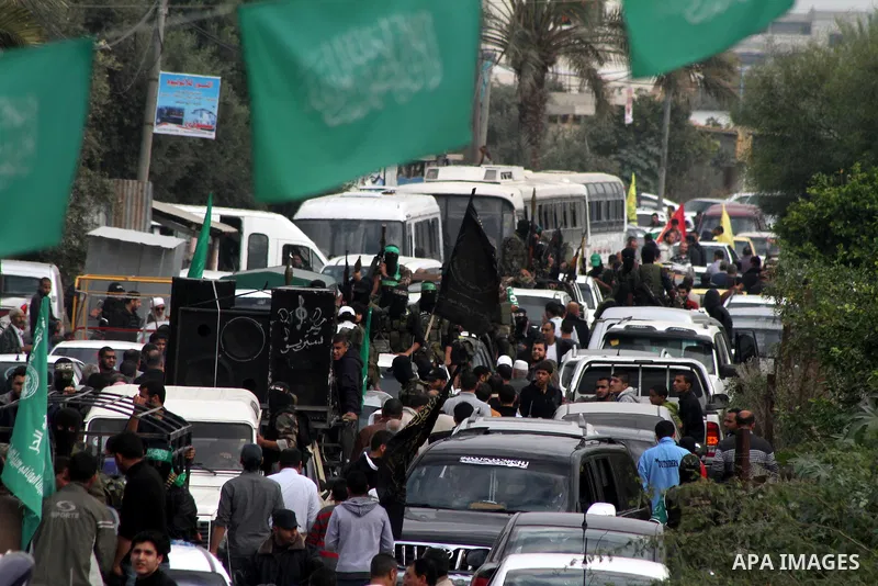 Hamas militants ride in a pick-up truck as they take part in the funeral of their comrades, whom medics said were killed in Israeli air strikes on Wednesday, in the central Gaza Strip November 22, 2012. A ceasefire betwe...