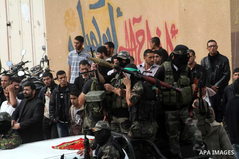 Hamas militants ride in a pick-up truck as they take part in the funeral of their comrades, whom medics said were killed in Israeli air strikes on Wednesday, in the central Gaza Strip November 22, 2012. A ceasefire betwe...