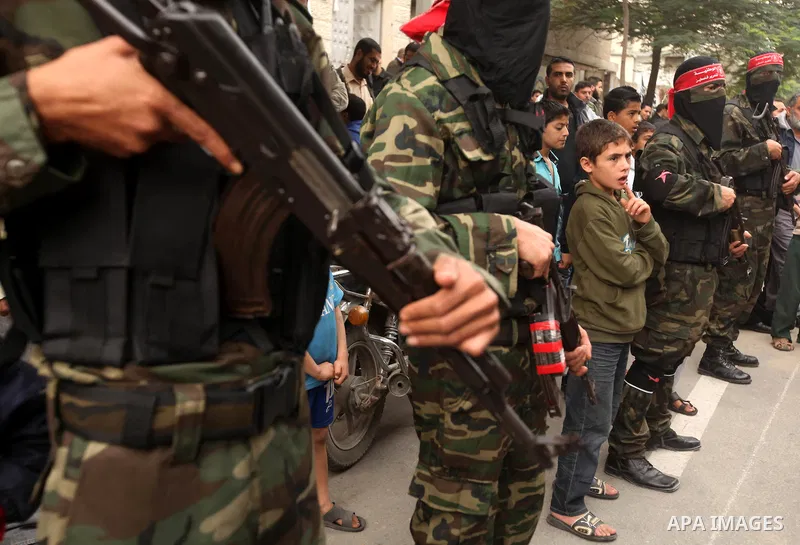 Palestinian militants from the Popular Front for the Liberation of Palestine (PFLP) attends the funeral of Mohammed Abdel-Rahman Ayesh, a militant from from the Al Nasser Brigades, an armed wing of the Popular Resistance...