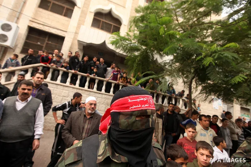 Palestinian militants from the Popular Front for the Liberation of Palestine (PFLP) attends the funeral of Mohammed Abdel-Rahman Ayesh, a militant from from the Al Nasser Brigades, an armed wing of the Popular Resistance...