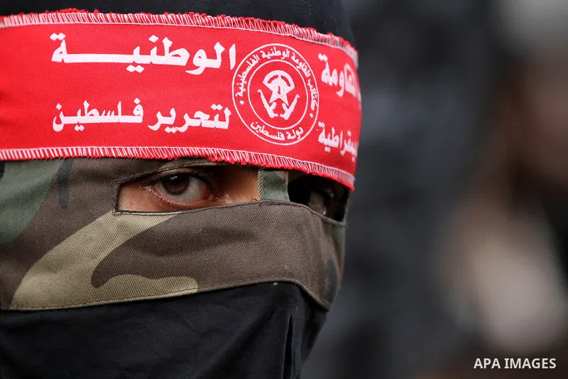 Palestinian militants from the Popular Front for the Liberation of Palestine (PFLP) attends the funeral of Mohammed Abdel-Rahman Ayesh, a militant from from the Al Nasser Brigades, an armed wing of the Popular Resistance...