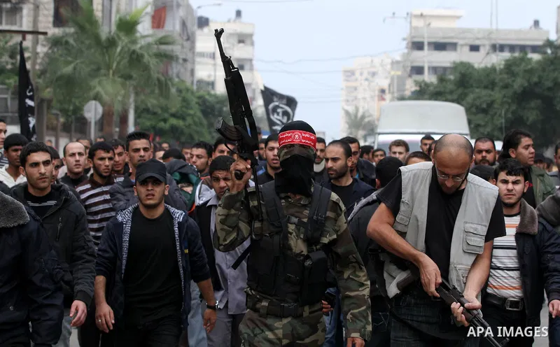 Palestinian militants from the Popular Front for the Liberation of Palestine (PFLP) attends the funeral of Mohammed Abdel-Rahman Ayesh, a militant from from the Al Nasser Brigades, an armed wing of the Popular Resistance...