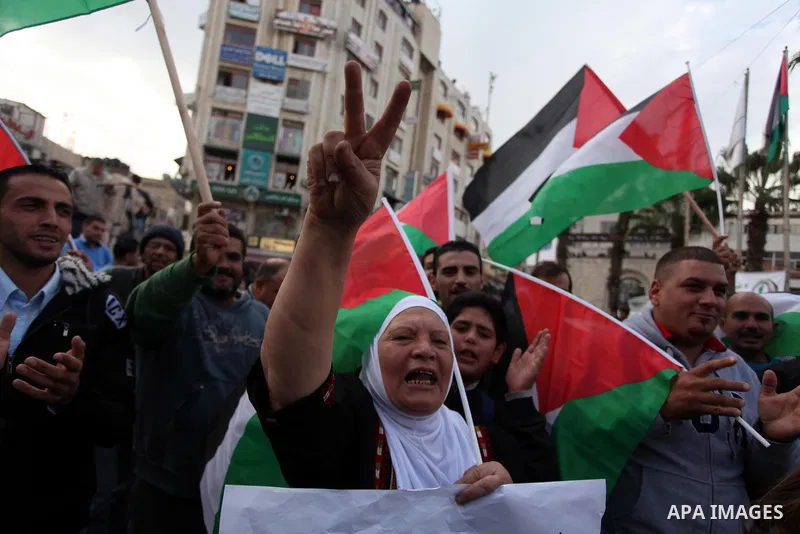 Palestinians celebrate what they call a victory over Israel, in the West Bank city of Ramallah, Nov. 22, 2012. Eight days of punishing Israeli airstrikes on Gaza and a barrage of Hamas rocket fire on Israeli ended inconc...