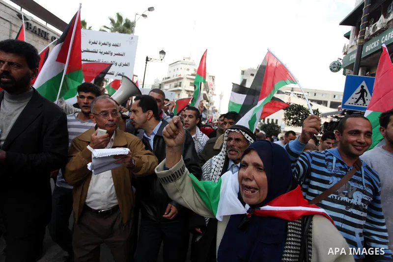 Palestinians celebrate what they call a victory over Israel, in the West Bank city of Ramallah, Nov. 22, 2012. Eight days of punishing Israeli airstrikes on Gaza and a barrage of Hamas rocket fire on Israeli ended inconc...