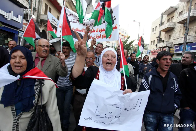 Palestinians celebrate what they call a victory over Israel, in the West Bank city of Ramallah, Nov. 22, 2012. Eight days of punishing Israeli airstrikes on Gaza and a barrage of Hamas rocket fire on Israeli ended inconc...
