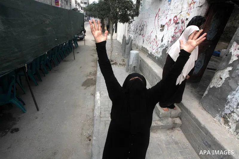 Relatives of three-year-old Reham Al Nabaheen mourn during her funeral in Al Nusairat refugee camp in the central Gaza Strip, 22 November 2012. Reham Al Nabaheen was reportedly killed after an Israeli air strike on Al Bu...