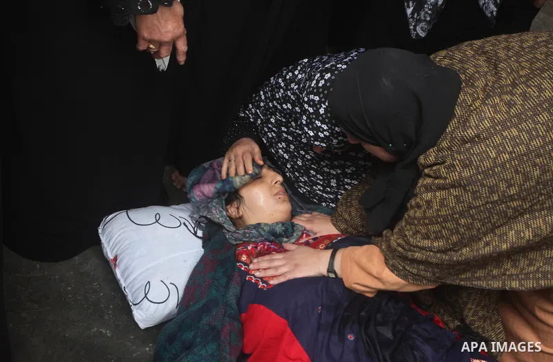 Relatives of three-year-old Reham Al Nabaheen mourn during her funeral in Al Nusairat refugee camp in the central Gaza Strip, 22 November 2012. Reham Al Nabaheen was reportedly killed after an Israeli air strike on Al Bu...