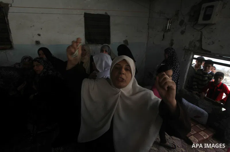 Relatives of three-year-old Reham Al Nabaheen mourn during her funeral in Al Nusairat refugee camp in the central Gaza Strip, 22 November 2012. Reham Al Nabaheen was reportedly killed after an Israeli air strike on Al Bu...