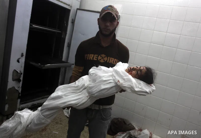 A man holds the body of his daughter, three-year-old Reham Al Nabaheen, during her funeral at Al Nusairat refugee camp in central Gaza Strip, 22 November 2012. Reham Al Nabaheen was reportedly killed after an Israeli air...