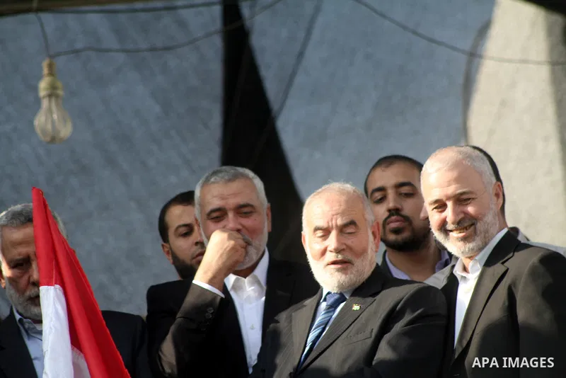 Palestinian prime minister in Gaza Ismail Haniyeh and Islamic Jihad leader Mohammed Al-Hindi, senior Fatah official Nabil Shaath and deputy speaker of Palestinian Parliament Ahmed Bahar celebrate what Palestinians say is...