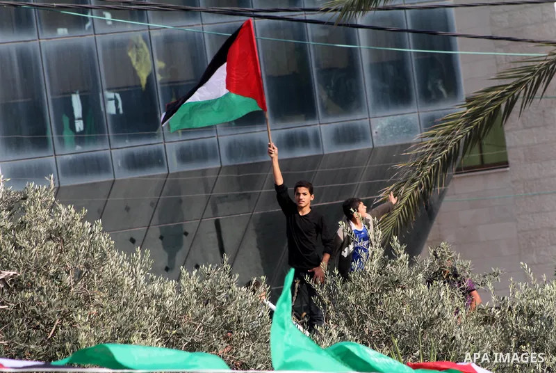 A Palestinian celebrates what Palestinians say is a victory over Israel after an eight-day conflict, during a rally in Gaza City November 22, 2012. A ceasefire between Israel and Gaza's Hamas rulers took hold on Thursday...