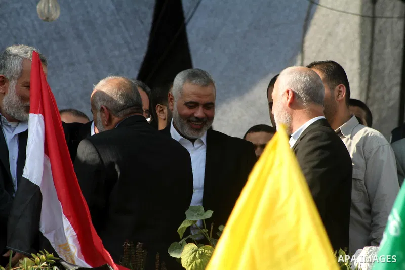 Palestinian prime minister in Gaza Ismail Haniyeh and Islamic Jihad leader Mohammed Al-Hindi, senior Fatah official Nabil Shaath and deputy speaker of Palestinian Parliament Ahmed Bahar celebrate what Palestinians say is...