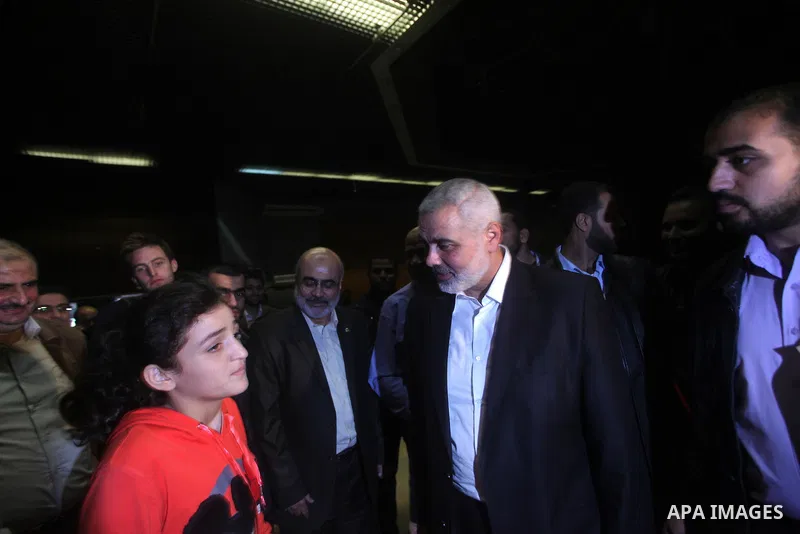 Palestinian prime minister in Gaza, Ismail Haniya with fellow Hamas members after delivering a speech in Gaza City on November 22, 2012. The ruling Hamas movement declared the day to be a public holiday to mark the end o...