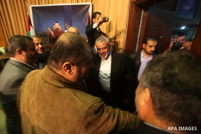 Palestinian prime minister in Gaza, Ismail Haniya with fellow Hamas members after delivering a speech in Gaza City on November 22, 2012. The ruling Hamas movement declared the day to be a public holiday to mark the end o...