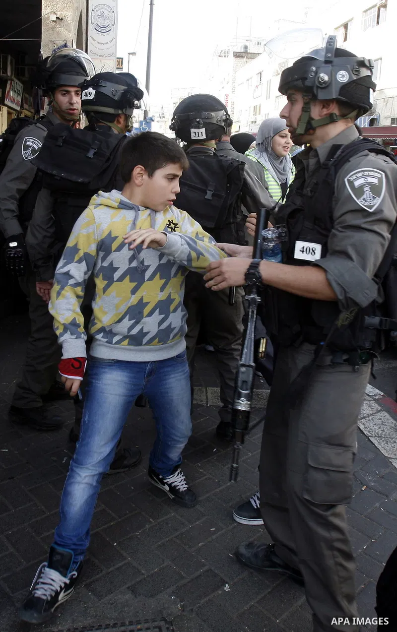 Israeli forces arrest a Palestinian Child on November 22, 2012 after Palestinians threw stones at a police station in Salahaddin street, a main commercial area of mostly Arab east Jerusalem. The incident followed the det...