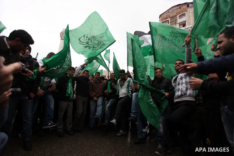 Palestinians wave Hamas flags during a rally celebrating what they claim to be Hamas' victory over Israel in the Gaza conflict, in the West Bank city of Ramallah November 23, 2012. Israeli troops at the Gaza border shot...