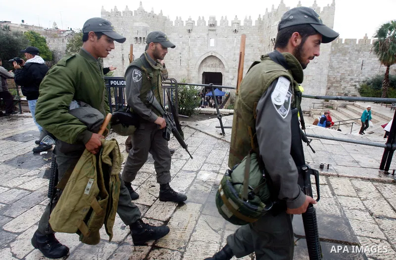 Israeli border police officers stand guard outside Damascus Gate in Jerusalem's Old City November 23, 2012. Israeli security forces declared an age limit on Friday for Palestinians wanting to enter the Old City, only all...
