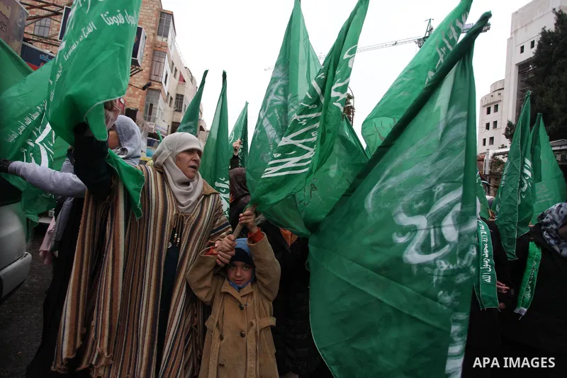 Palestinians wave Hamas flags during a rally celebrating what they claim to be Hamas' victory over Israel in the Gaza conflict, in the West Bank city of Ramallah November 23, 2012. Israeli troops at the Gaza border shot...