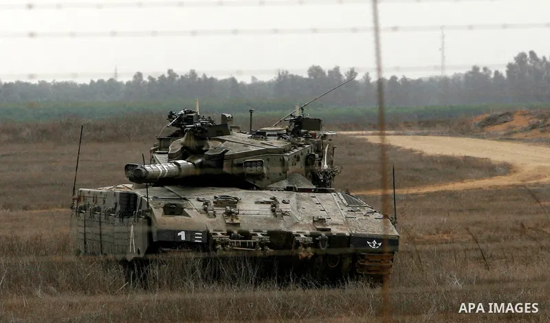 An Israeli tank stands ready on the border between Gaza strip and Israel in the east of Khan Younis southern Gaza strip November 23, 2012. Israeli troops at the Gaza border shot dead a Palestinian man and wounded 15 more...