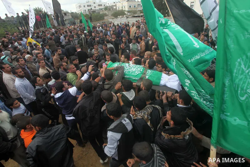 Palestinians carry the body of Anwar Qudih, 20, during his funeral in Khan Younis, southern Gaza Strip, Nov. 23, 2012. Israeli troops at the Gaza border shot dead Qudeh and wounded 15 more on Friday, health officials sai...
