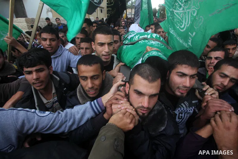 Palestinians carry the body of Anwar Qudih, 20, during his funeral in Khan Younis, southern Gaza Strip, Nov. 23, 2012. Israeli troops at the Gaza border shot dead Qudeh and wounded 15 more on Friday, health officials sai...