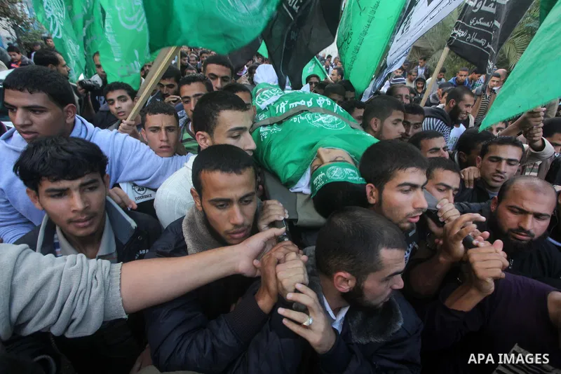 Palestinians carry the body of Anwar Qudih, 20, during his funeral in Khan Younis, southern Gaza Strip, Nov. 23, 2012. Israeli troops at the Gaza border shot dead Qudeh and wounded 15 more on Friday, health officials sai...