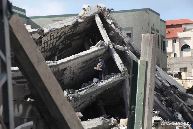 A Palestinian man stand at the rubble of a house, which was destroyed by an Israeli airstrike, in Gaza City on Nov. 24, 2012. Israel and Palestinian militant groups in the Gaza Strip reached a ceasefire agreement on Wedn...
