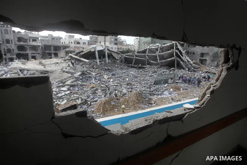 A Palestinian school boy looks through a hole at their damaged United Nations run school in Gaza City, on November 24, 2012, three days after a truce was declared between Israel and Hamas. Gaza's children, virtually abse...