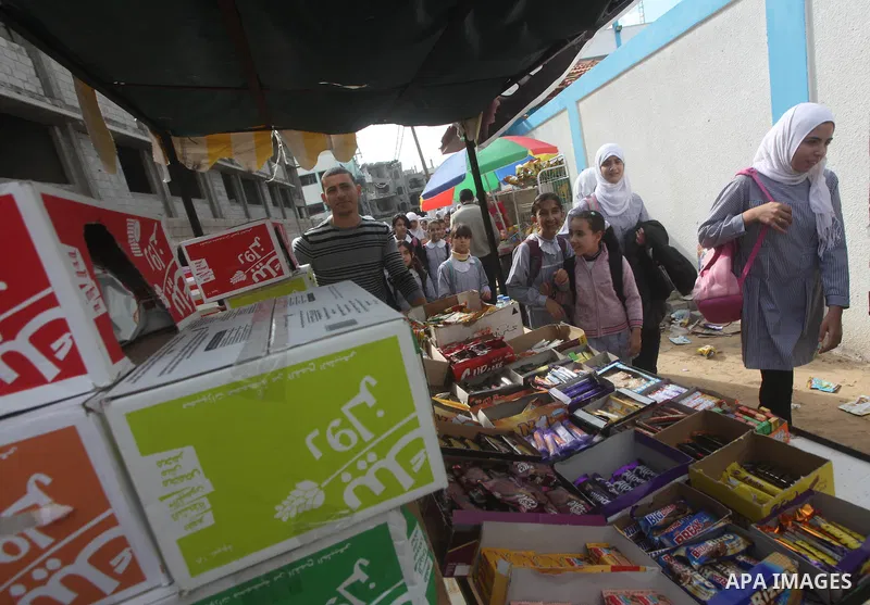 Palestinians school girls walk on the rubble of a building destroyed during earlier Israeli bombardment, as they make their way to their nearby school in Gaza City, on November 24, 2012, three days after a truce was decl...