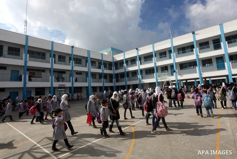 Palestinians school girls walk on the rubble of a building destroyed during earlier Israeli bombardment, as they make their way to their nearby school in Gaza City, on November 24, 2012, three days after a truce was decl...