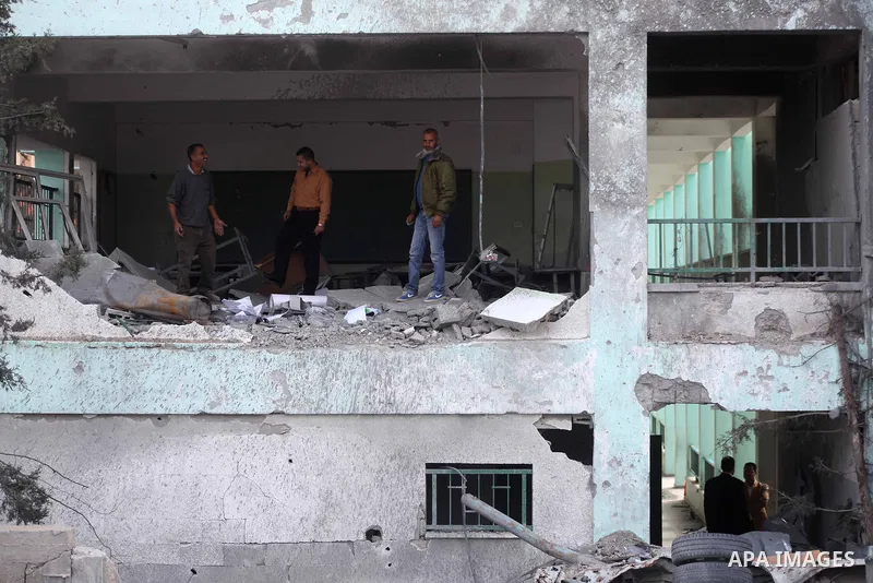 Palestinians stand at the rubble of a house, which was destroyed by an Israeli airstrike, in Gaza City on Nov. 24, 2012. Israel and Palestinian militant groups in the Gaza Strip reached a ceasefire agreement on Wednesday...