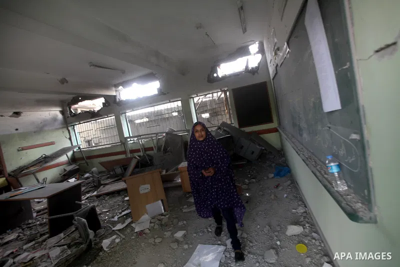 A Palestinian girl walks on the rubble of a building destroyed during earlier Israeli bombardment, as they make their way to their nearby school in Gaza City, on November 24, 2012, three days after a truce was declared b...