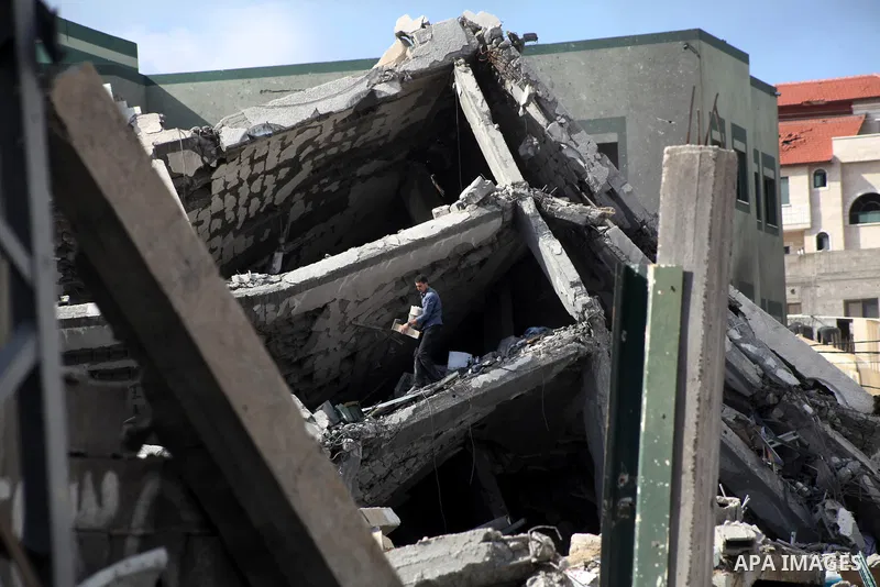 A Palestinian man stand at the rubble of a house, which was destroyed by an Israeli airstrike, in Gaza City on Nov. 24, 2012. Israel and Palestinian militant groups in the Gaza Strip reached a ceasefire agreement on Wedn...
