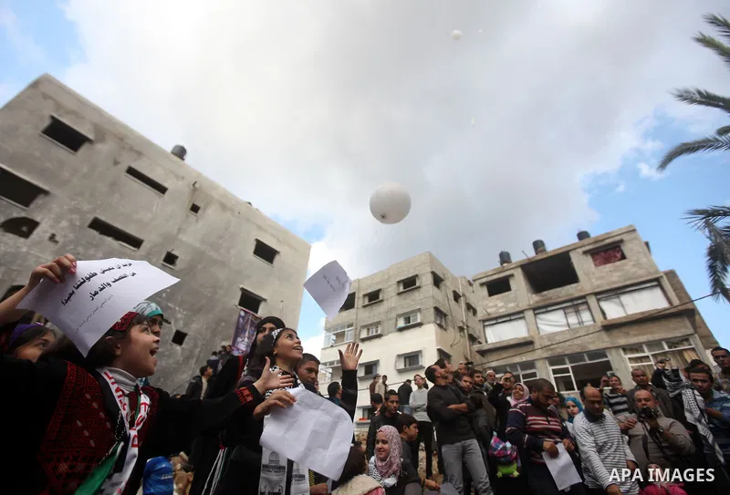 Palestinians release balloons at the site of the destroyed house of the Dalou family in Gaza City November 24, 2012. Eleven members of the Dalou family were killed after an Israeli air strike on their house during the ei...