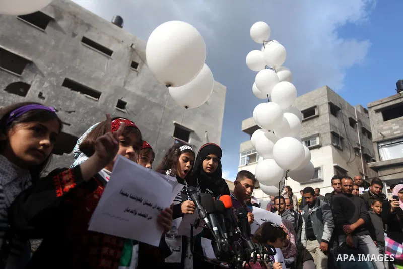 Palestinians release balloons at the site of the destroyed house of the Dalou family in Gaza City November 24, 2012. Eleven members of the Dalou family were killed after an Israeli air strike on their house during the ei...