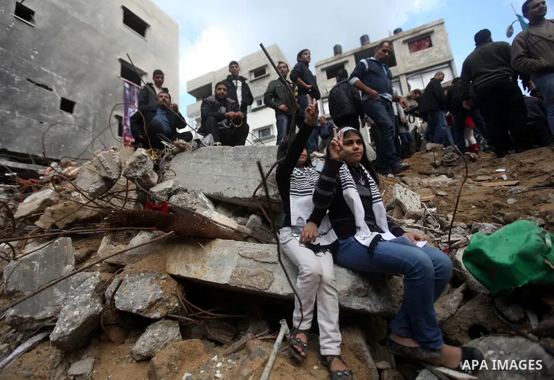 Palestinians release balloons at the site of the destroyed house of the Dalou family in Gaza City November 24, 2012. Eleven members of the Dalou family were killed after an Israeli air strike on their house during the ei...