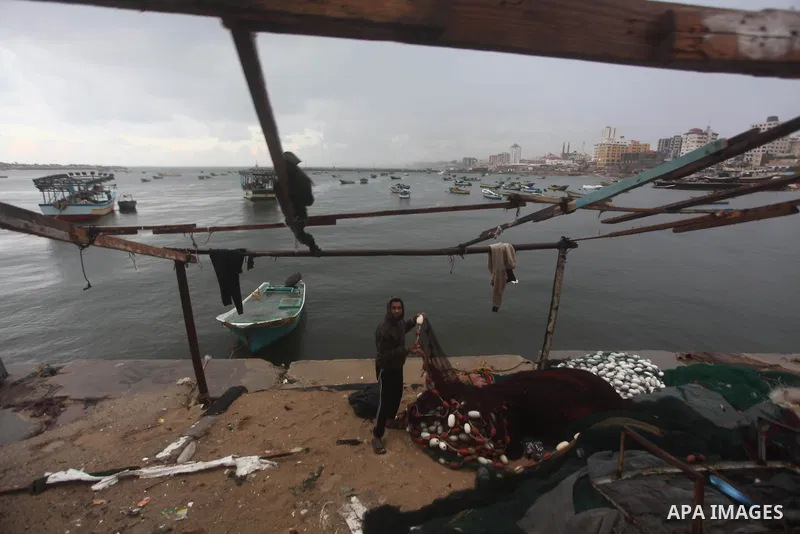 Palestinian fishermen prepare their boats in the port of Gaza on the Mediterranean coast in Gaza City on November 24, 2012, as a fragile truce between Israel and militant groups in Gaza enters its third day. Israel slamm...