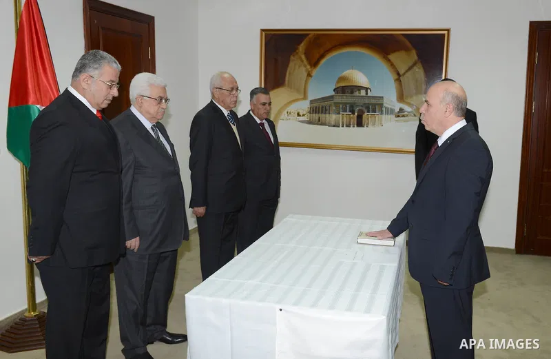 Mohammed led Abdul Ghani Oweiwi, legal right, in front of President Mahmoud Abbas (Abu Mazen), Attorney General of the State of Palestine in the West Bank city of Ramalllah. on Nov. 24, 2012. Photo by Thaer Ganaim