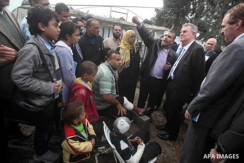 Robert H. Serry, the United Nations special coordinator for the Middle East Peace Process, talks with a wounded Palestinian man during his visit to Gaza Strip in Gaza City on Nov. 25, 2012. Photo by Ashraf Amra