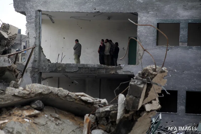 Employees of the Palestinian Interior ministry pray in the rubble of the Interior Ministry building in Gaza City on November 25, 2012, days after a truce between Hamas and Israel, ended eight days of cross border attacks...