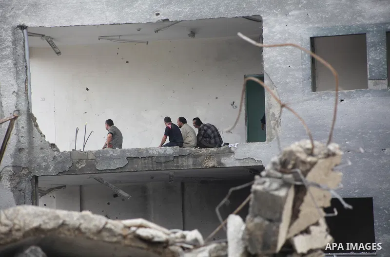 Employees of the Palestinian Interior ministry pray in the rubble of the Interior Ministry building in Gaza City on November 25, 2012, days after a truce between Hamas and Israel, ended eight days of cross border attacks...