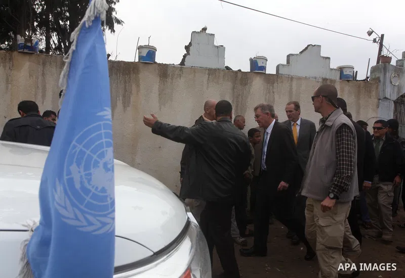 Robert H. Serry, the United Nations special coordinator for the Middle East Peace Process, talks with a wounded Palestinian man during his visit to Gaza Strip in Gaza City on Nov. 25, 2012. Photo by Ashraf Amra