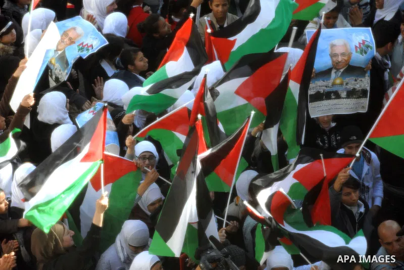 Palestinian President Mahmoud Abbas (not seen) gestures as he speaks during a rally supporting the Palestinian UN bid for observer state status, in the West Bank city of Ramallah, Sunday, Nov. 25, 2012. The Palestinians...