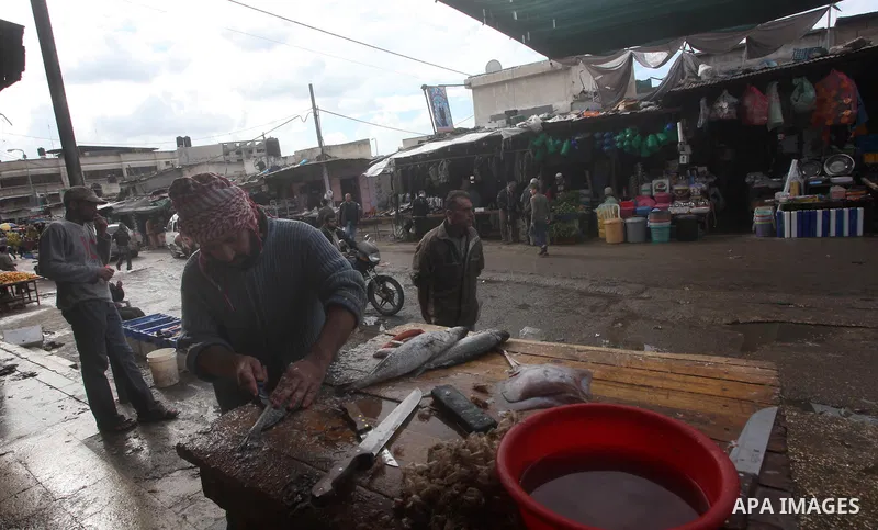 A Palestinian man sells fish at a market in Gaza City, 25 November 2012. Normal life in Gaza resumed remarkably fast after a ceasefire agreement was announced following eight days of cross border violence between Israel...