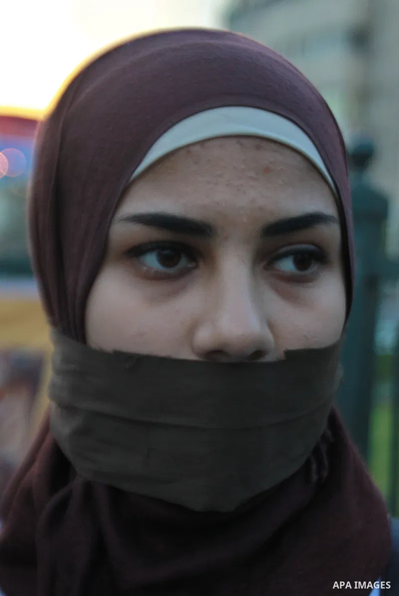 A Palestinian woman holds a poster of Palestinian prisoners during a protest calling for the release them from Israeli jails and in support of prisoners on hunger strike, in the West Bank city of Nablus on 26 November 20...