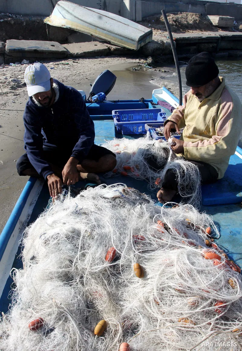 Palestinian fishermen prepare their boats in the port of Gaza on the Mediterranean coast, on Nov. 26, 2012, as a fragile truce between Israel and militant groups in Gaza enters its third day. Israel slammed Palestinian p...