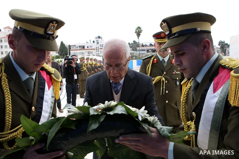 Tayeb Abdel Rahim (front), secretary-general of the Palestinian presidency, places a wreath at the tomb of late Palestinian leader during a ceremony in the West Bank city of Ramallah, on Nov. 27, 2012. Samples of the rem...