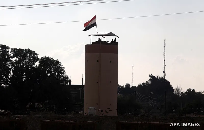 Egyptian border police stand guards on a control tower near the Egyptian-Gaza border in Rafah, in the southern Gaza Strip November 27, 2012. Knee-deep in craters carved out by Israeli air strikes, Palestinians wielded sh...